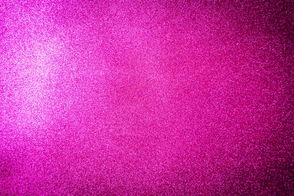 Vibrant pink glitter background with shimmering texture, ideal for festive designs.