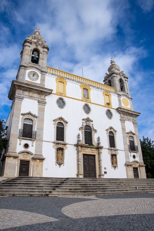 Free View of the historic Igreja do Carmo church under a blue sky in Faro, Portugal. Stock Photo