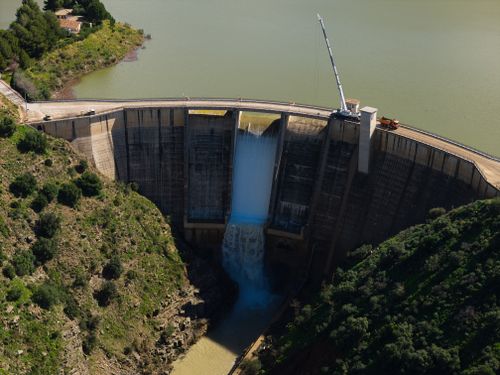 Free A stunning aerial shot of Casasola Dam in Almogía, showcasing its impressive structure and tranquil surroundings. Stock Photo