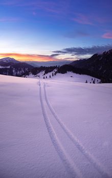 Breathtaking winter scene of snow-covered Dolomites at sunset, ideal for travel and nature enthusiasts.