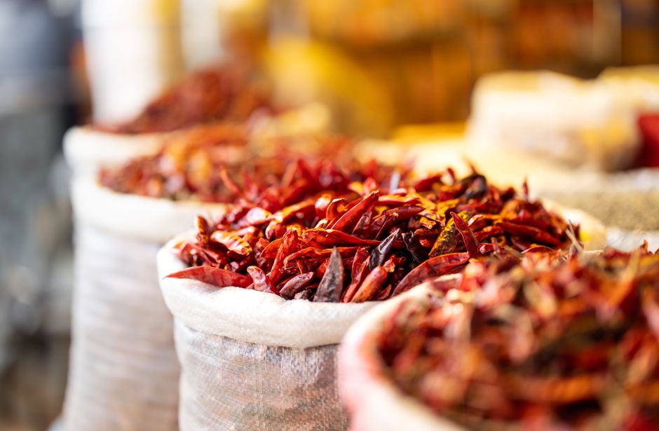 A vibrant stall selling various aromatic spices like chai masala in a market in Kerala, India