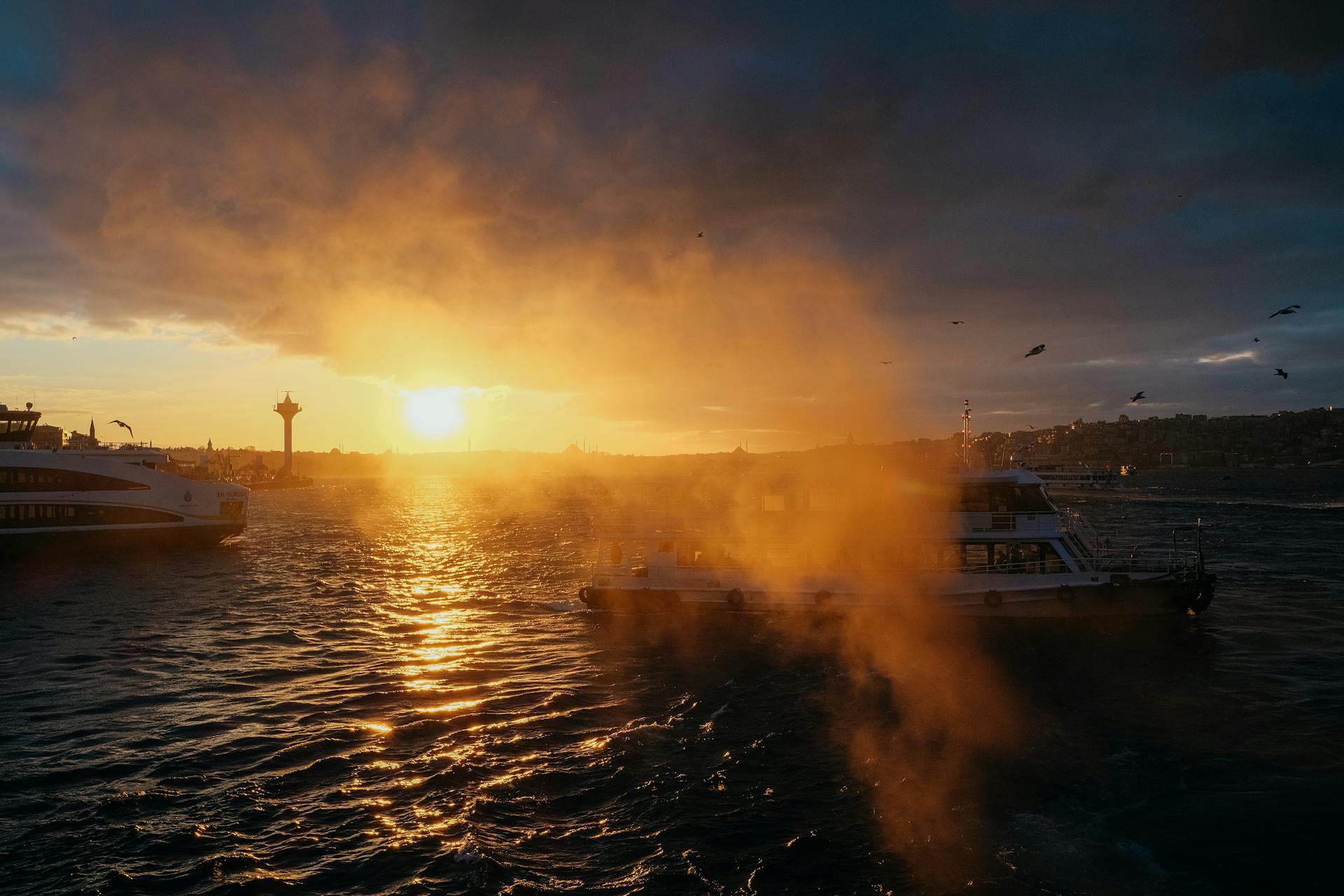 Ferries sail under a golden sunset on Istanbul's Bosphorus, capturing the city's vibrant atmosphere.