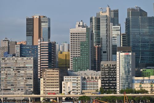 Free Vibrant modern city skyline showcasing tall skyscrapers against a clear blue sky. Stock Photo