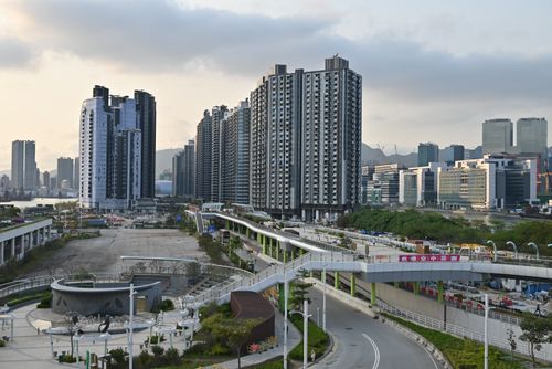 Free Cityscape view of high-rise buildings and overpass. Modern urban development captured during the day. Stock Photo