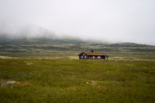 Free Tranquil wooden cabin set amidst the misty highlands of Buskerud, Norway. Stock Photo