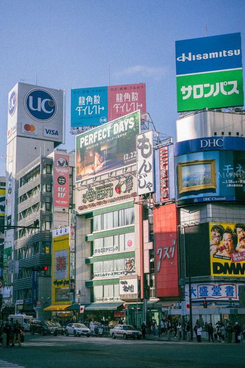 Free Bustling urban scene in Tokyo with colorful advertisements and busy crosswalk. Stock Photo