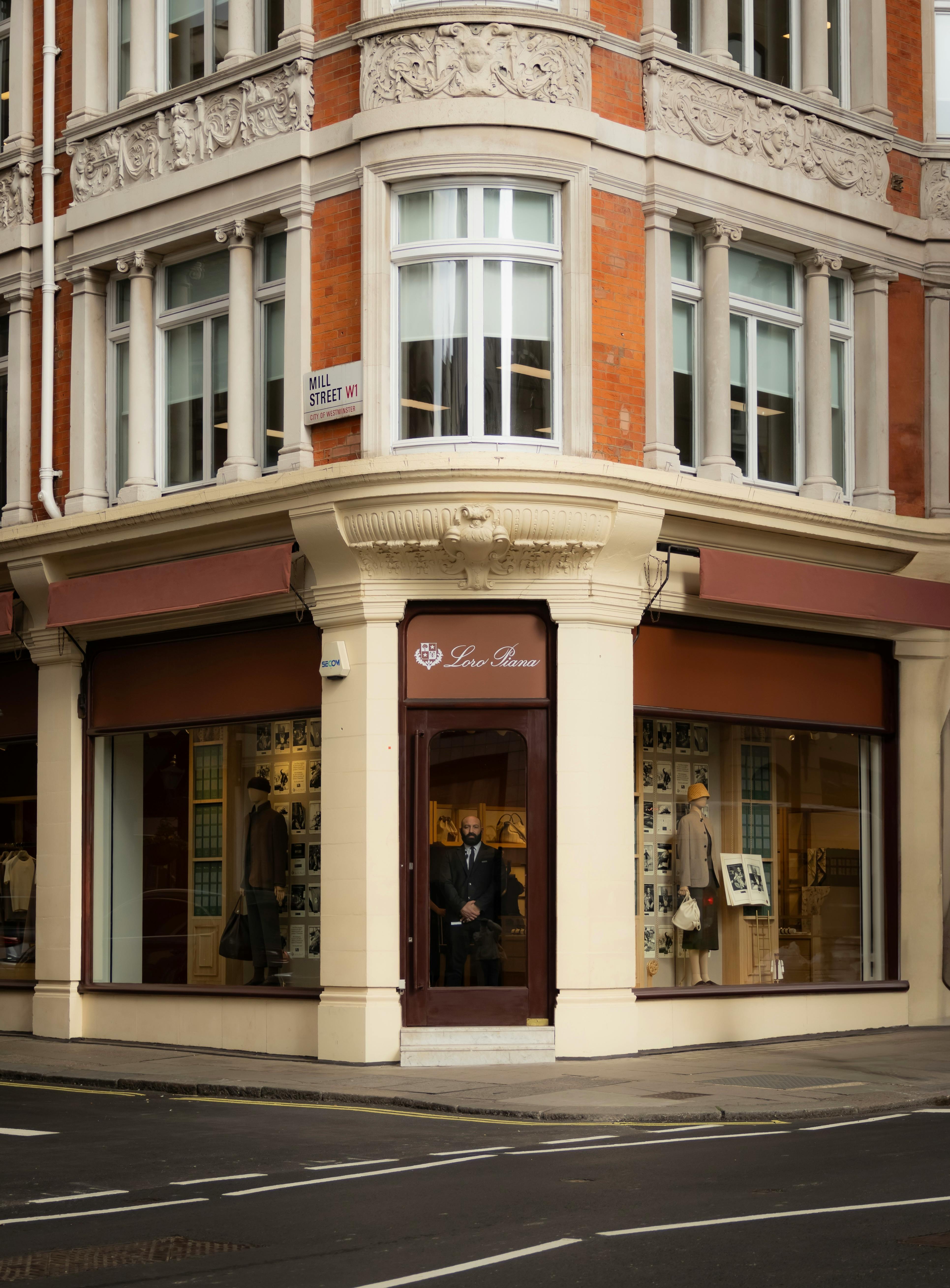 Charming London street scene with historic architecture and fashion boutique.