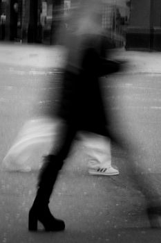 Capturing the dynamic and blurred silhouette of pedestrians on a busy London street.