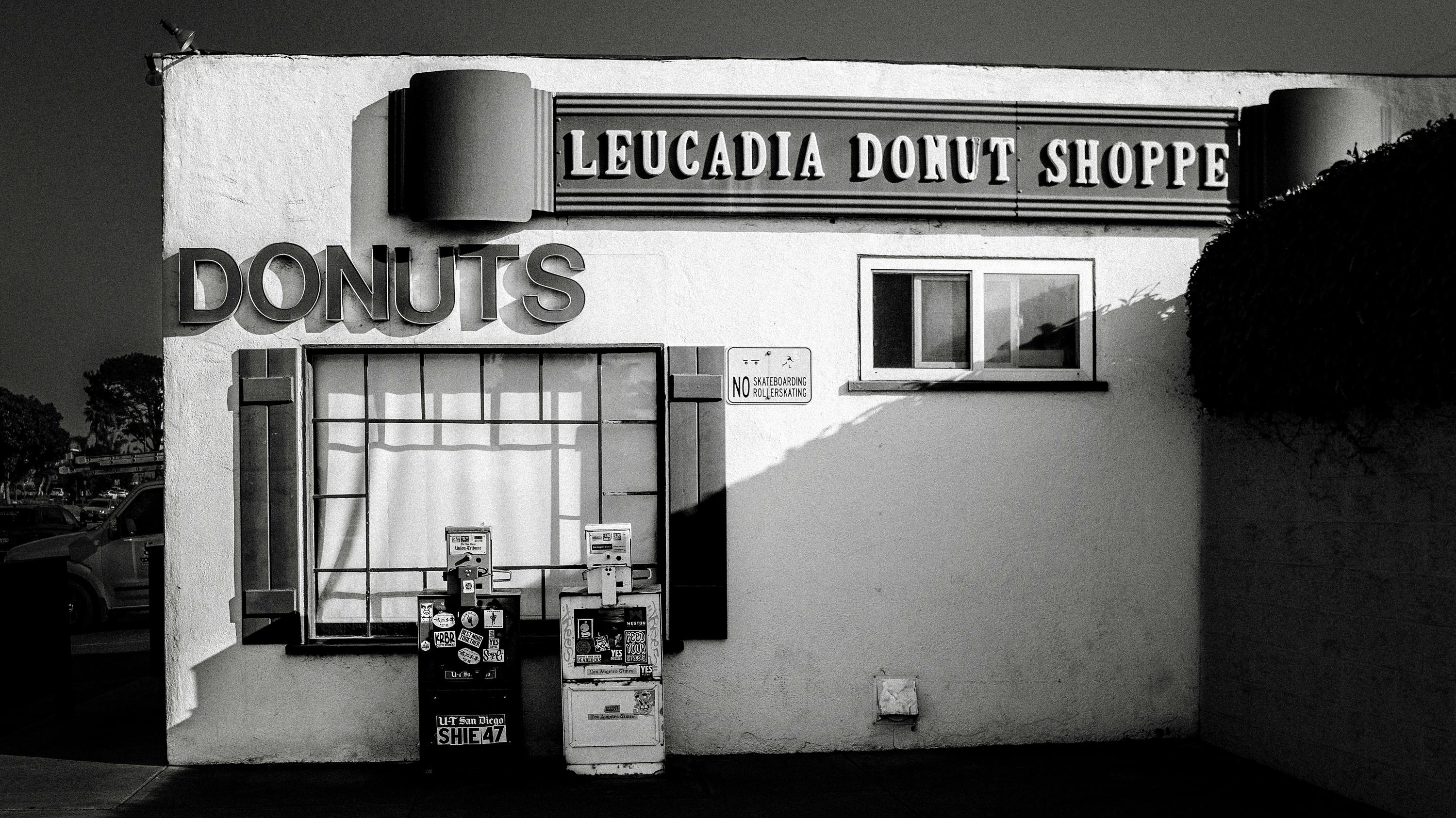 Classic black and white photo of Leucadia Donut Shoppe exterior, featuring retro signage in California.