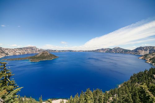 Free Stunning panoramic view of Crater Lake under a clear blue sky in Oregon. Stock Photo