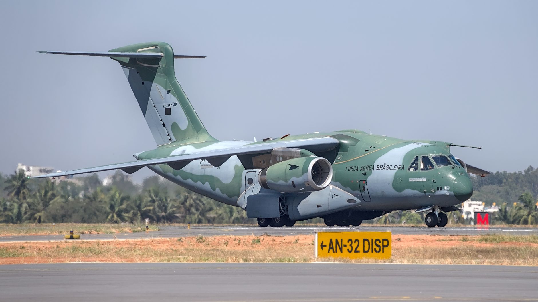 Military aircraft on runway at Bengaluru Airport. Air show event demonstration.