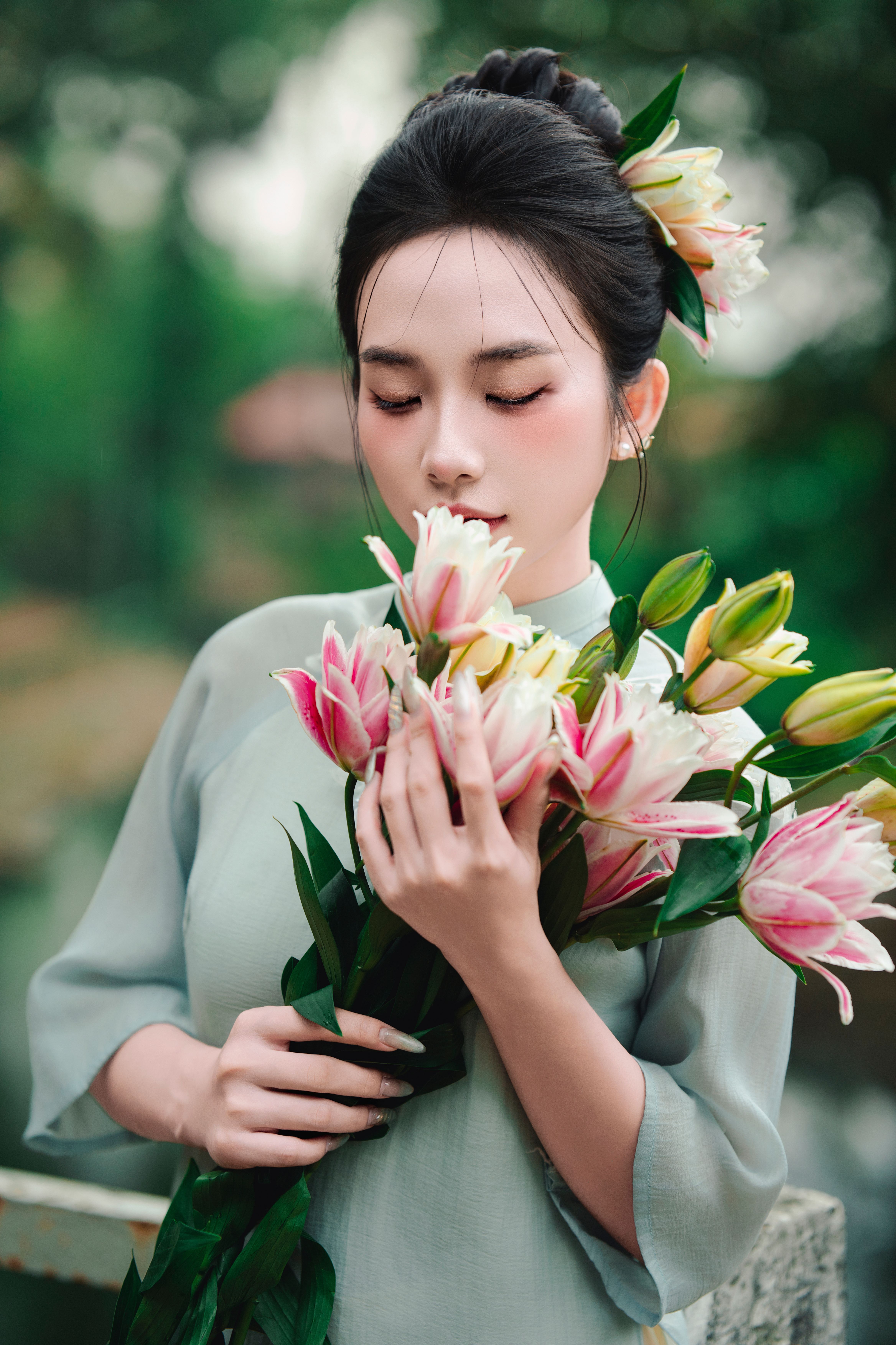 Young Woman Holding Elegant Pink Lilies Outdoors · Free Stock Photo