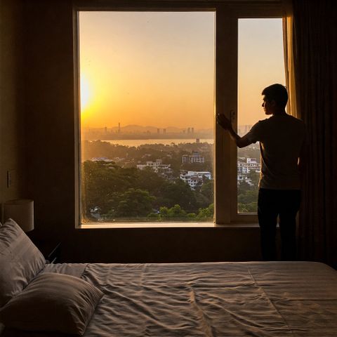 Cover art: figure at a window at sunset — photo by Jan Vee on Pexels