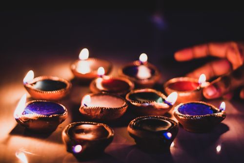 Free Vibrant display of lit diyas for Diwali festival creating a warm and festive atmosphere. Stock Photo
