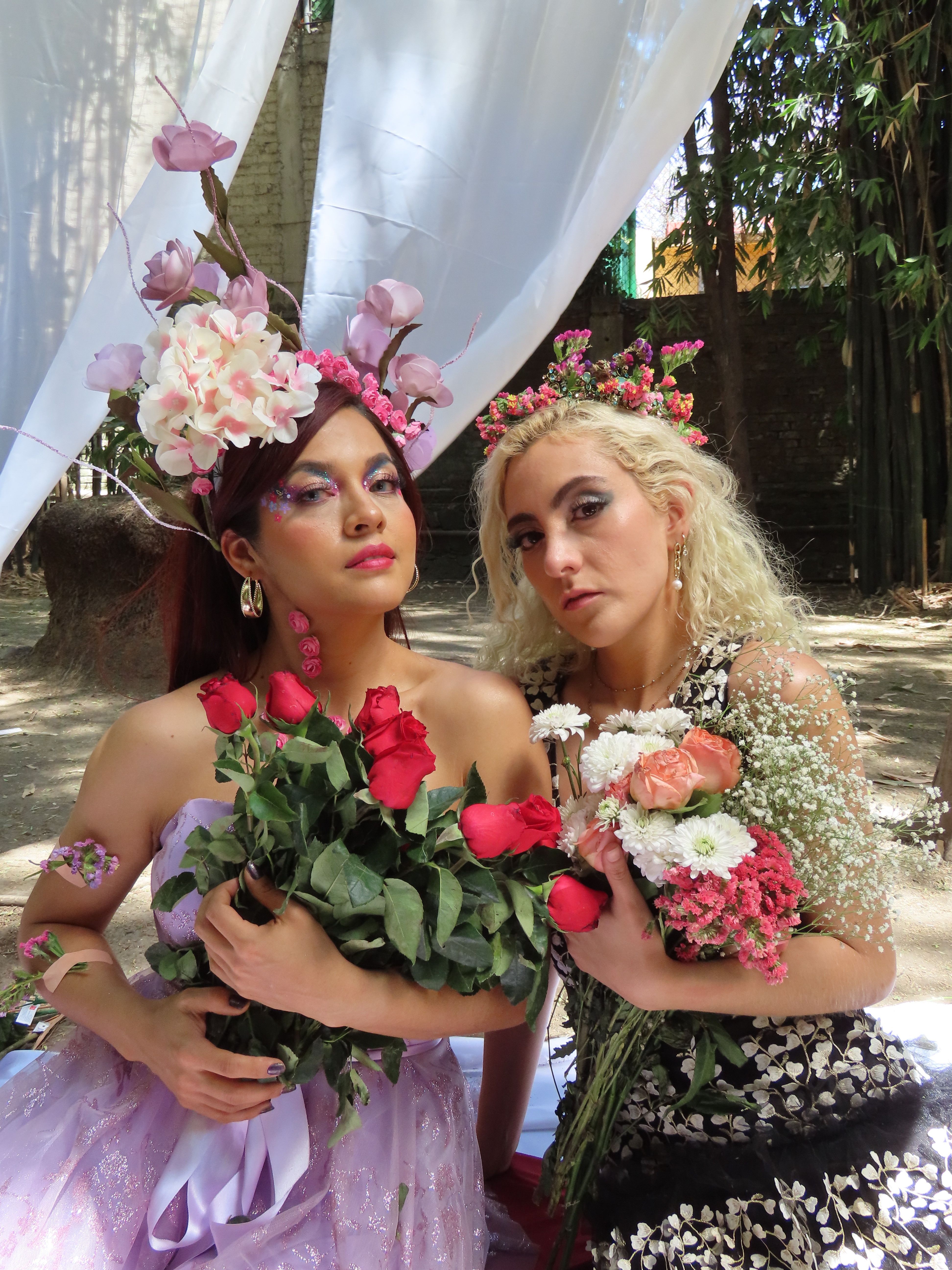 Elegant portrait of two women adorned with flowers, evoking a serene and artistic ambiance.