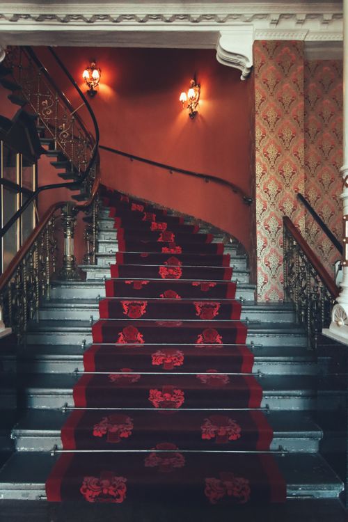 Free A beautifully designed vintage staircase with ornate carpet and warm lighting, Tokyo. Stock Photo