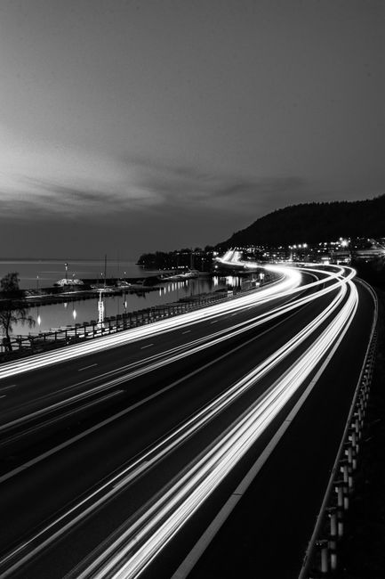 Mesmerizing black and white long exposure of highway lights in Huskvarna, Sweden.