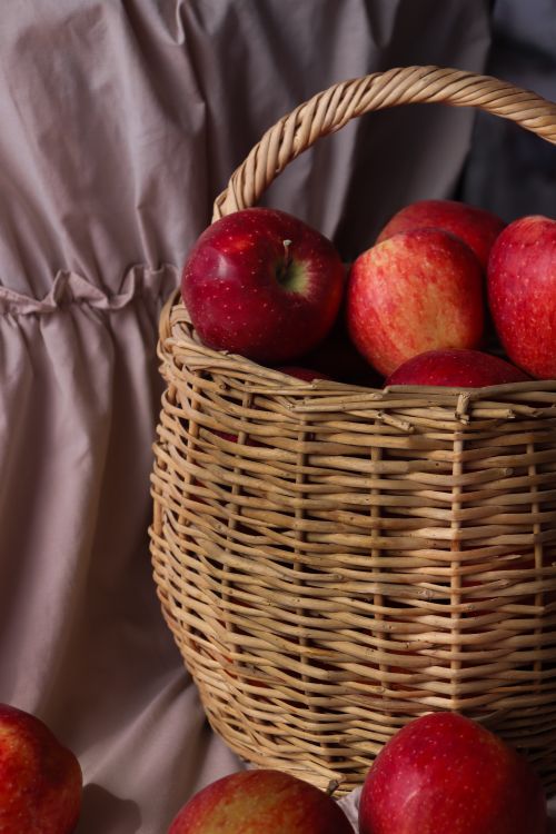 Free Aesthetic basket of red apples on a neutral background, showcasing vibrant colors and textures. Stock Photo