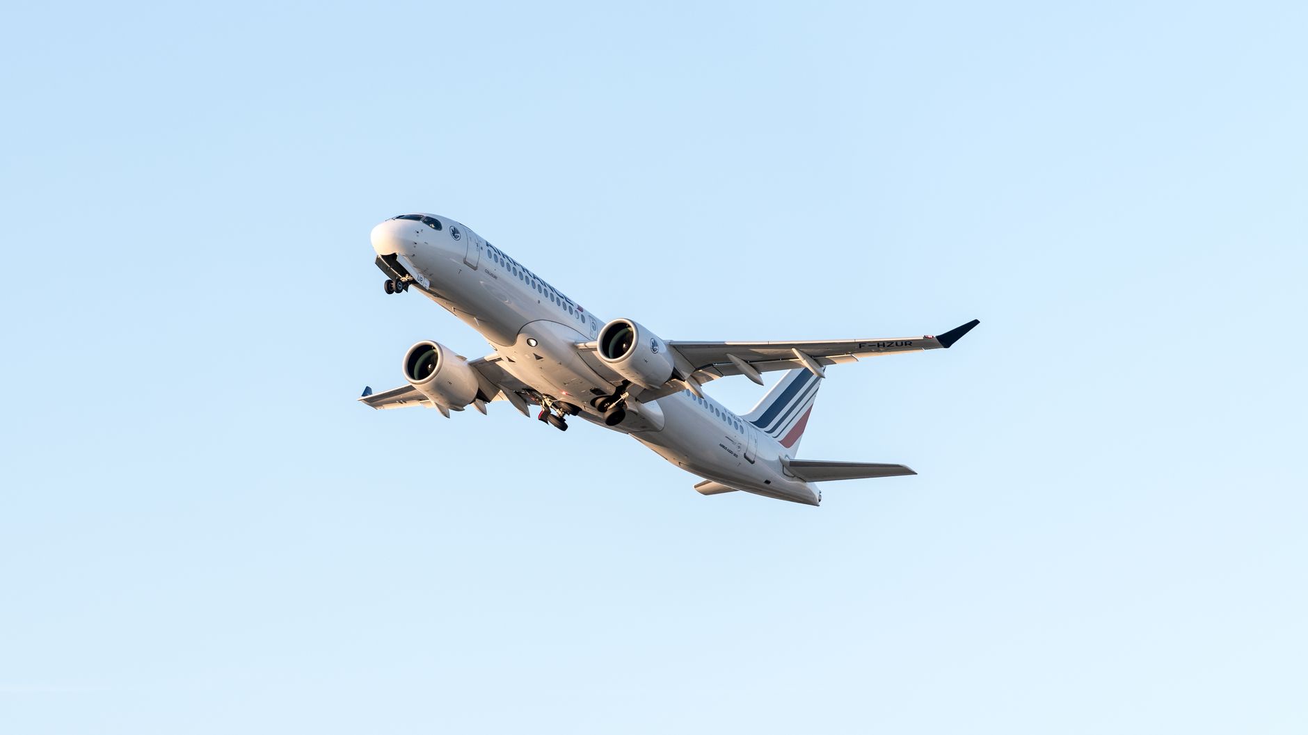 Jet aircraft flying high against a clear sky, showcasing air travel and aviation.