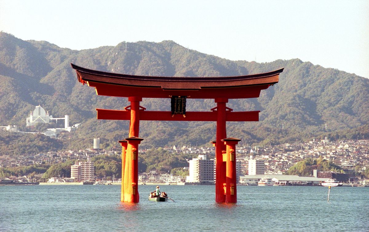 The great torii gate of Itsukushima Shrine at Miyajima, Hiroshima Prefecture — standing in the open water of the Seto Inland Sea at high tide