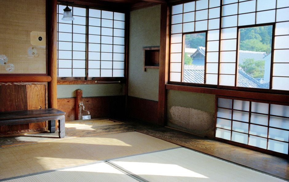 Cozy interior of a traditional Japanese ryokan in Takayama with futon bedding and a low table