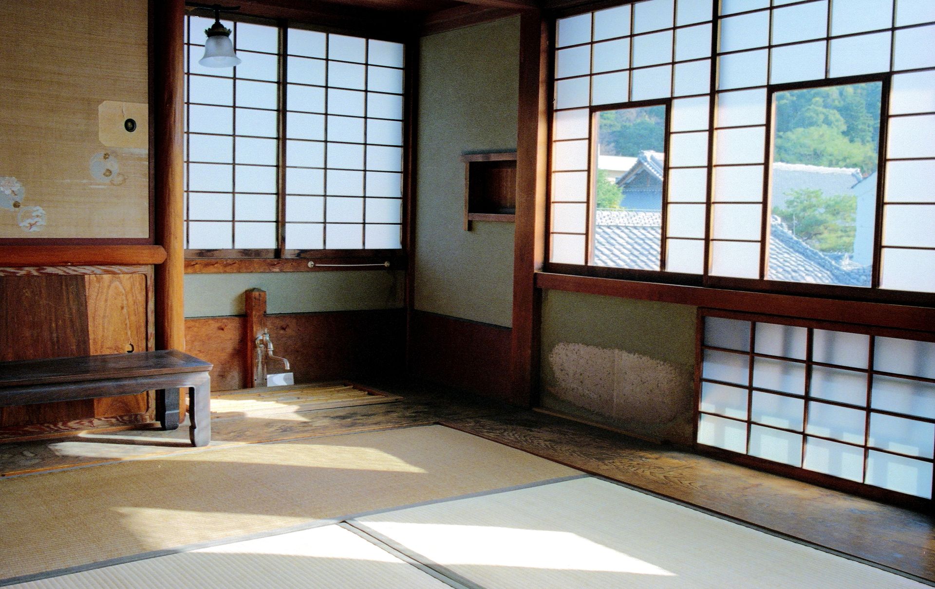 A serene washitsu room with tatami mats and shoji screens in a traditional Japanese setting.