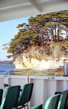 Experience the stunning coastal views of Matsushima Bay from a ferry, capturing serene islands and clear blue waters.