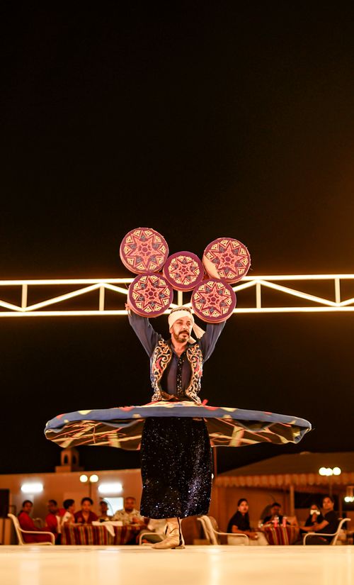 Free Captivating Tanoura dancer showcasing vibrant spinning art under night skies. Stock Photo