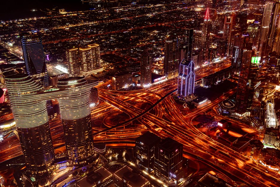 Breathtaking Dubai Iconic Helicopter Tour and Dhow Cruise Dinner Marina Combo Review Review 2026 - Breathtaking aerial view of Dubai cityscape at night with glowing skyscrapers and roads.