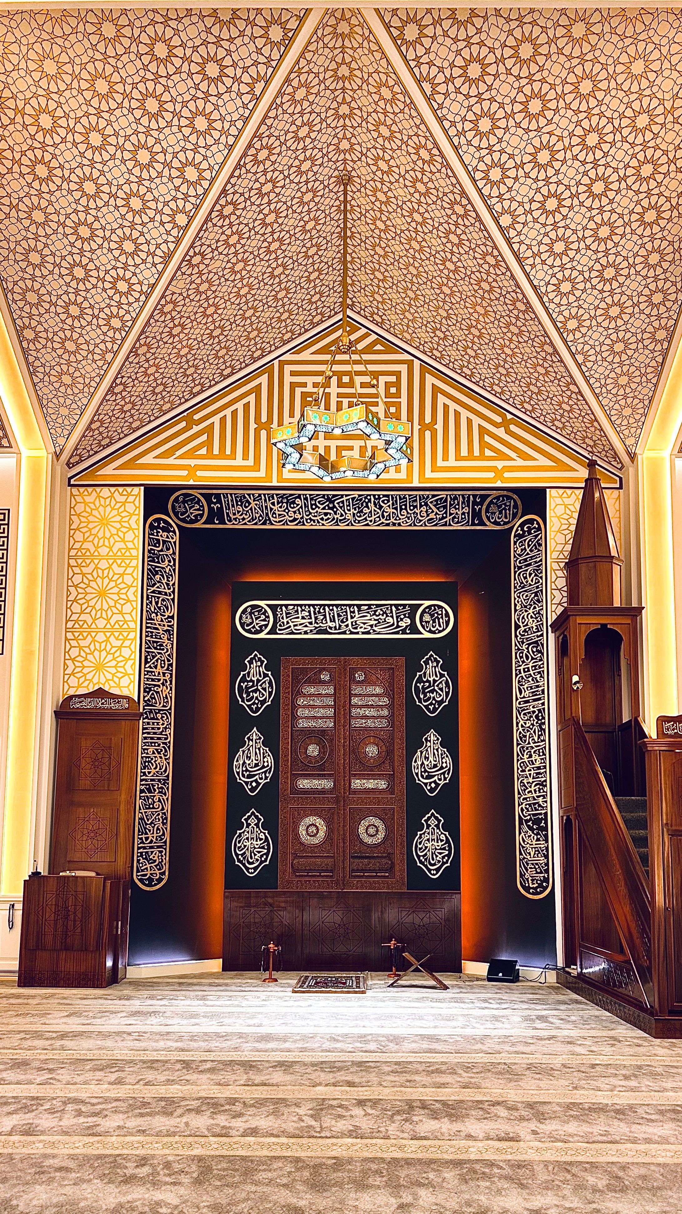 Ornate mosque prayer hall interior with carpet