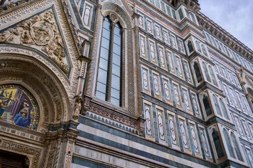Free Close-up of the ornate facade of Florence Cathedral, showcasing detailed architectural art. Stock Photo