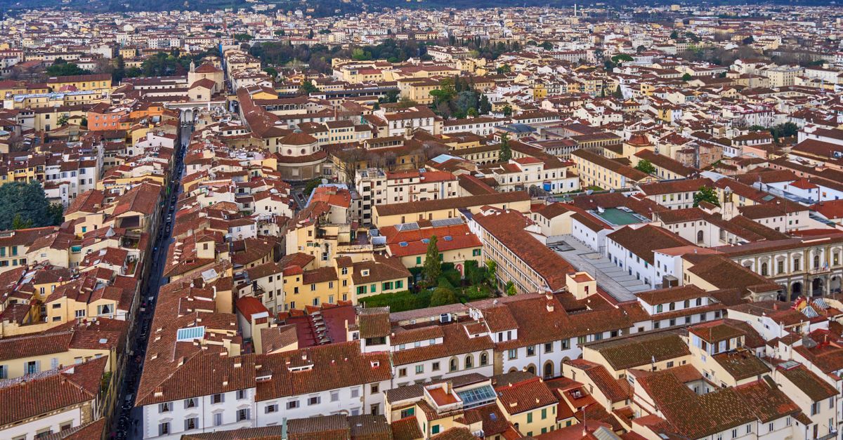 Aerial view showcasing Florence's iconic red-tiled rooftops and cityscape.