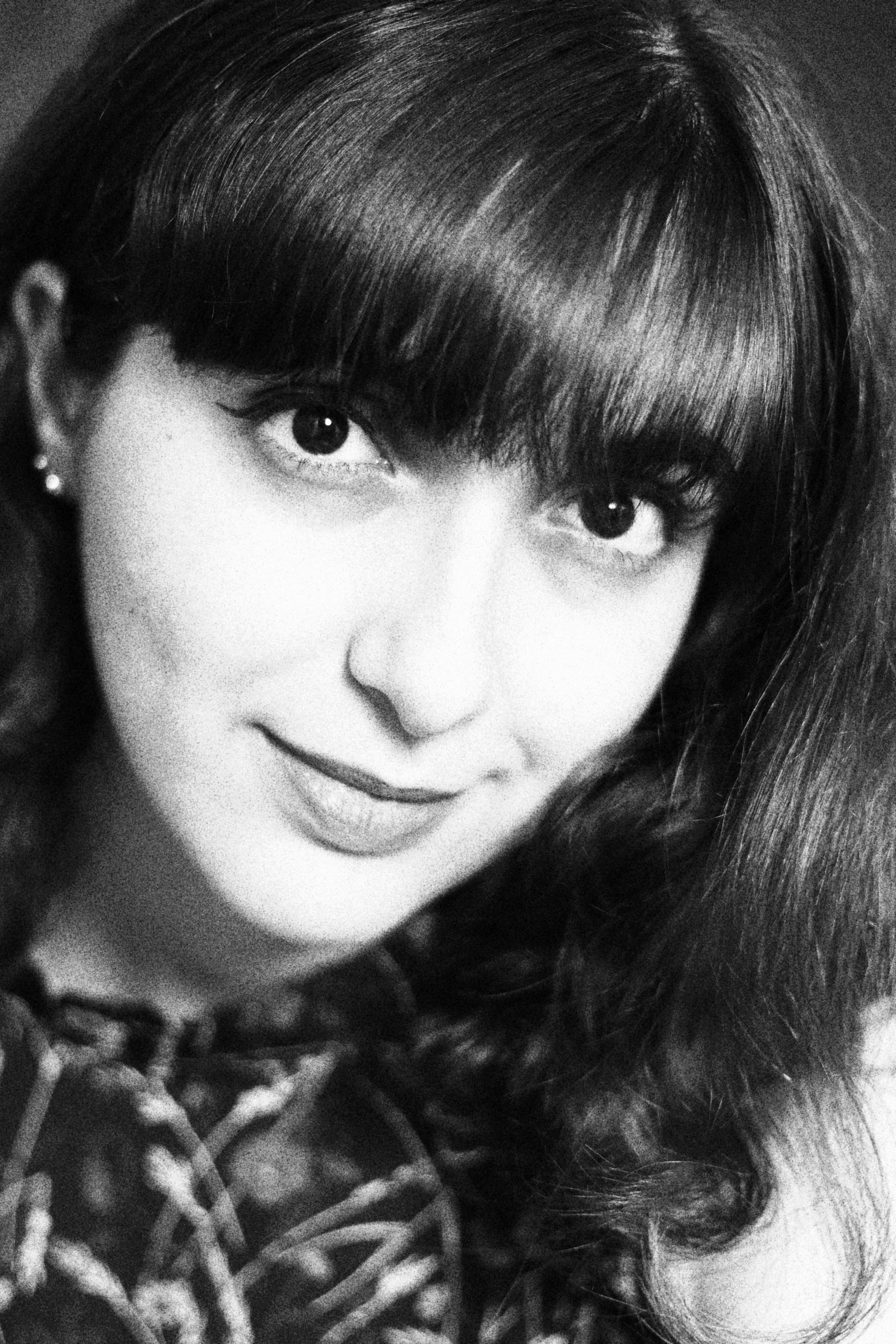 Artistic black and white portrait of a woman with bangs in São Paulo, Brazil.