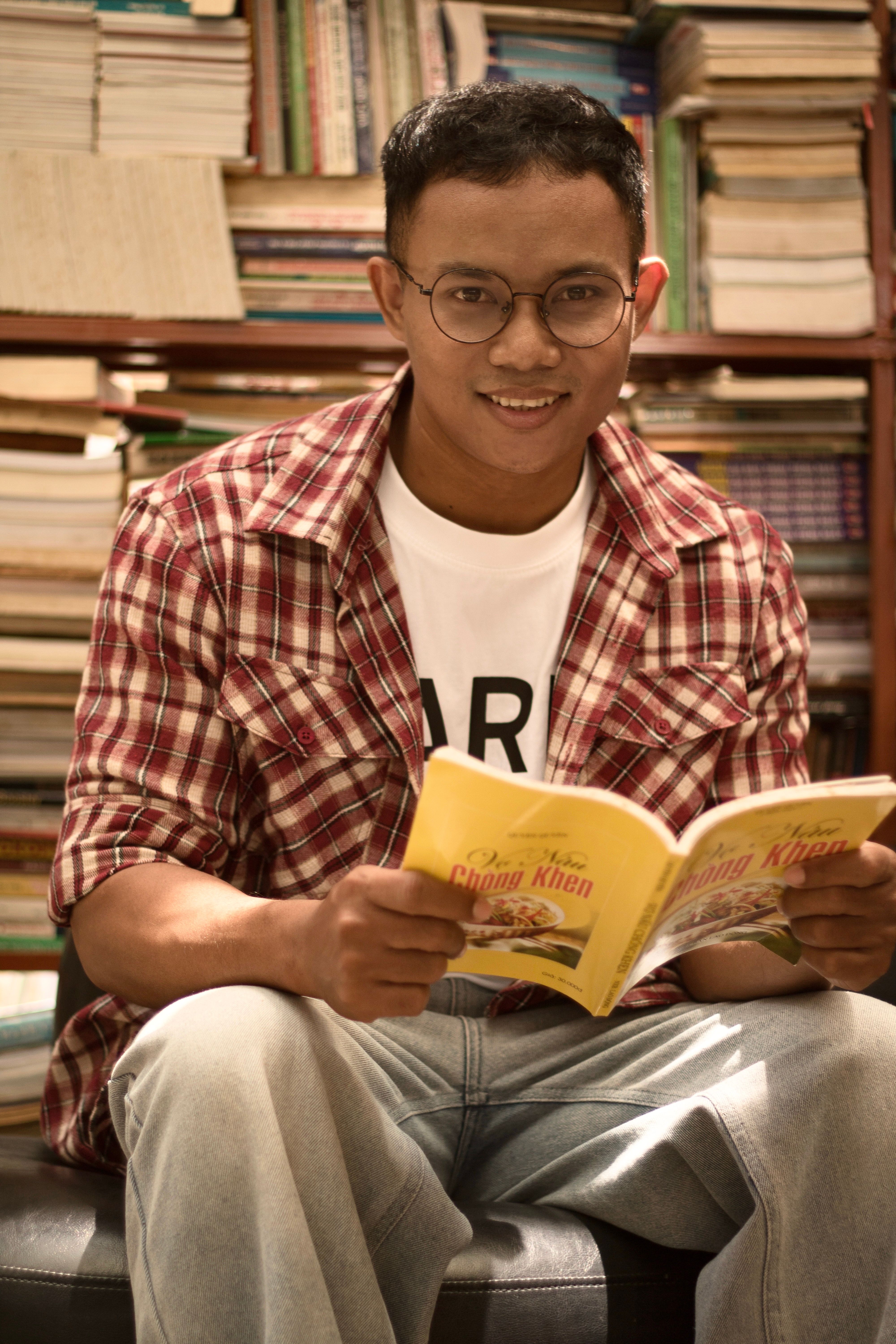 Smiling Man Reading in a Cozy Bookshop