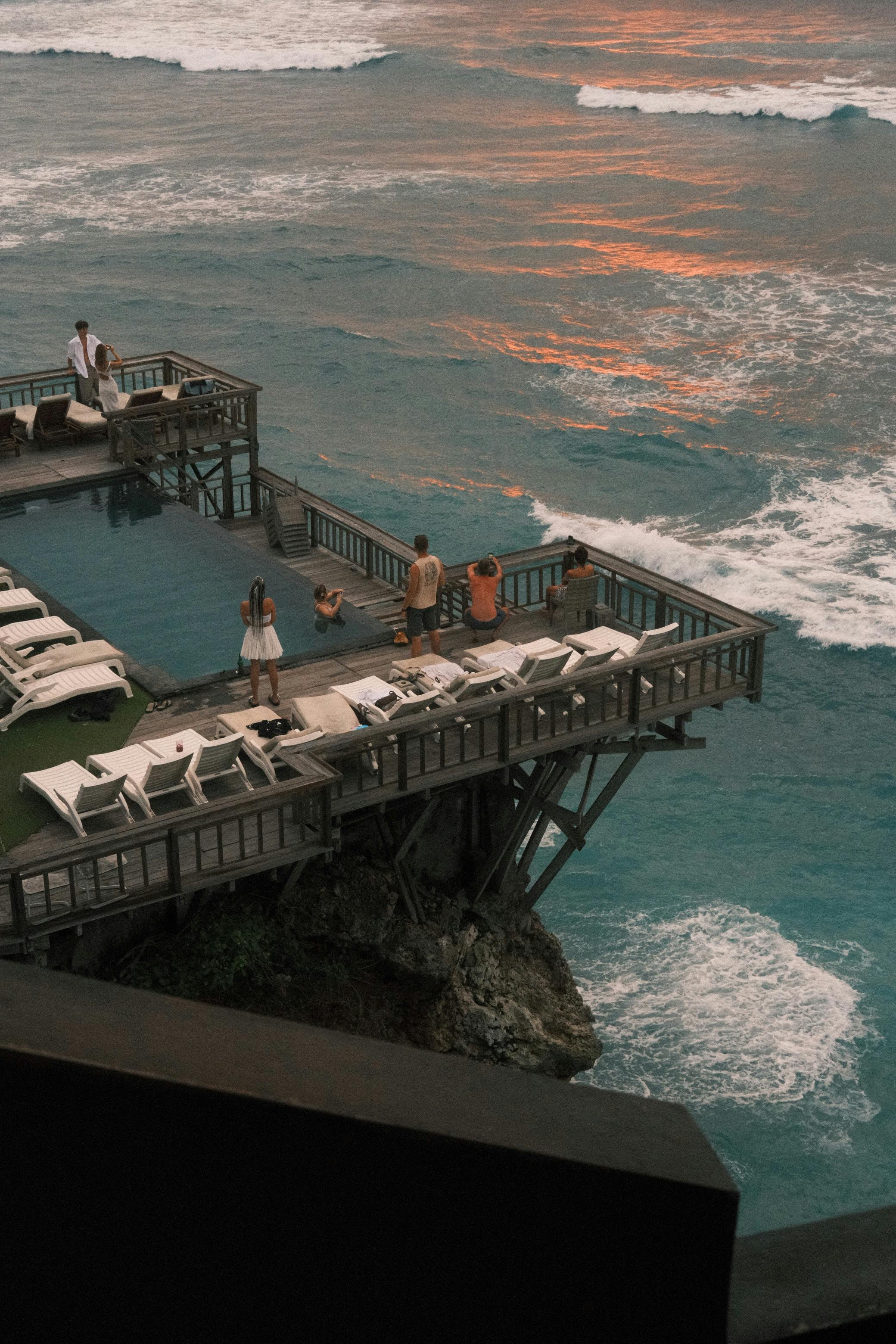 Clifftop infinity pool overlooking the Indian Ocean at sunset from a Uluwatu resort, one of the best places to stay in Bali for couples