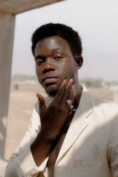 Elegant portrait of a young man in Zaria, Nigeria, showcasing unique style and confidence.