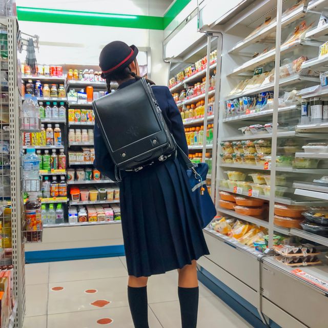 Shopper browsing snack shelves in a convenience store — photo by Zhenxing Cai on Pexels
