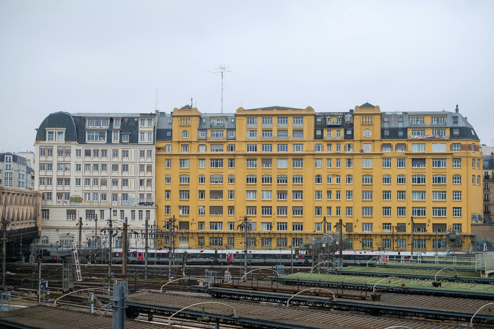 View of historic European buildings and train tracks showcasing urban architecture.