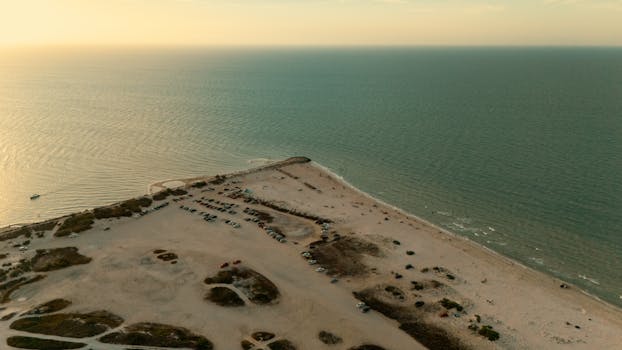 Stunning aerial view of Progreso Beach, Yucatan, Mexico at sunset, showing the serene coastline and sandy landscape.
