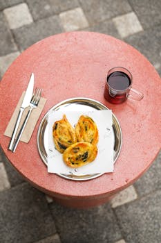 Top view of pastries and red drink on a table outdoors, perfect for culinary and lifestyle themes.