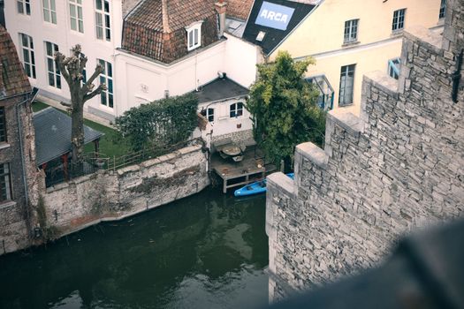 Cozy riverside view of historic architecture in Ghent, Belgium, featuring a canal with serene ambiance.