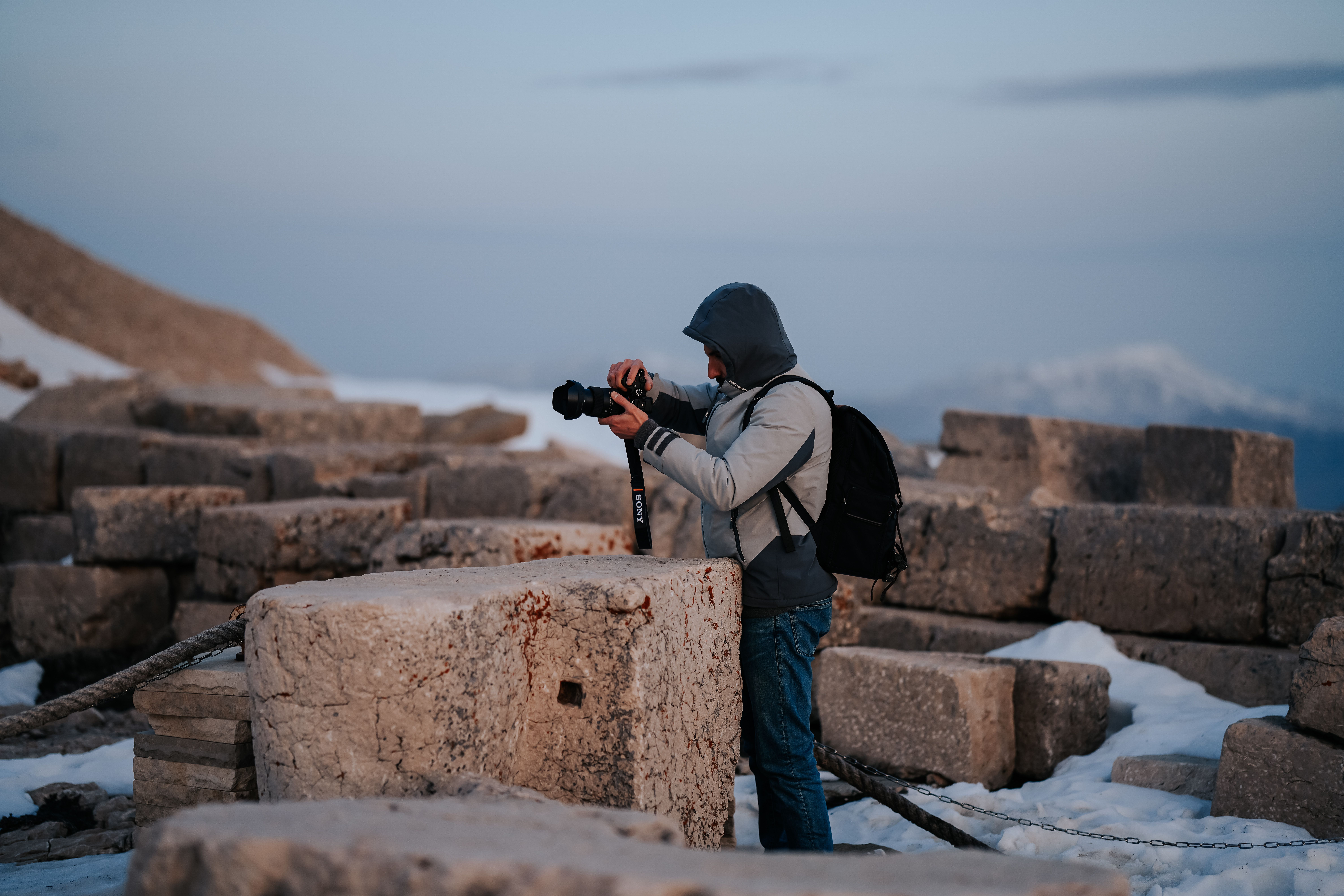 Photographer Exploring Ancient Ruins at Dusk · Free Stock Photo