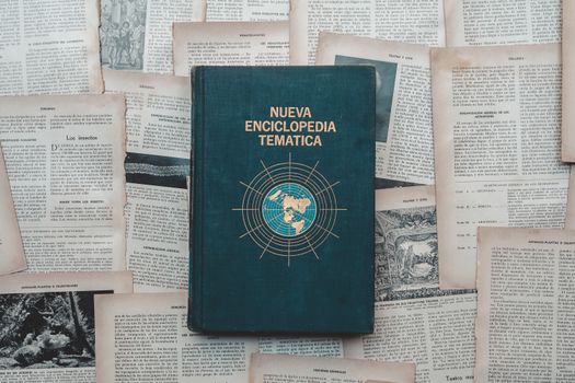 A classic encyclopedia book surrounded by historical text pages, evoking a sense of knowledge and history.