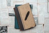 Vintage Books and Feather on Old Pages