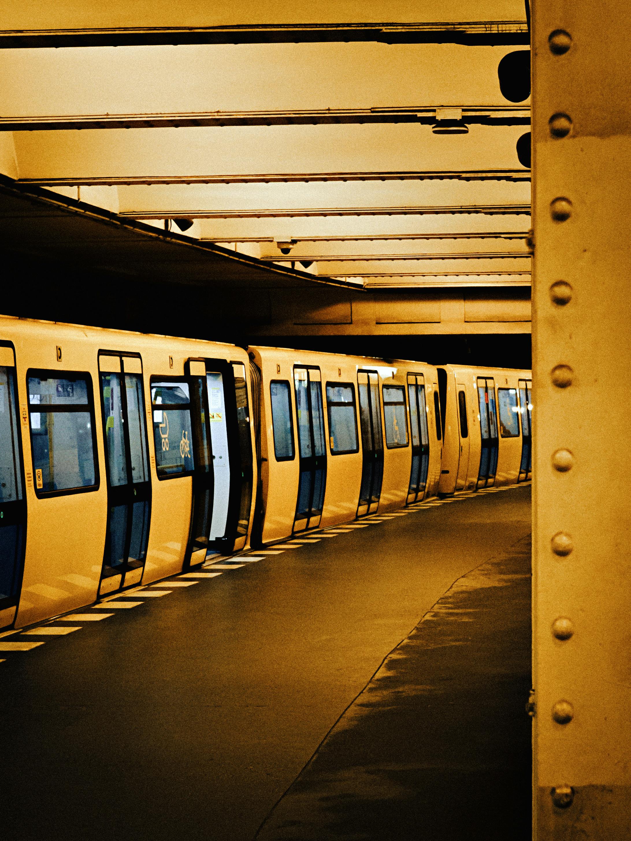 Empty Berlin train station with a line of waiting trains during daytime.