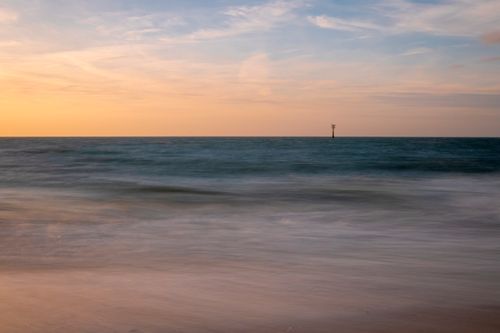 Free Peaceful sunset scene at Domburg beach, capturing the colorful sky over the North Sea. Stock Photo