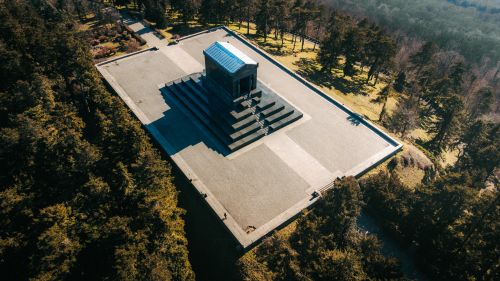Free Drone shot capturing the majestic monument surrounded by lush greenery in Beli Potok, Serbia. Stock Photo