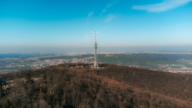 Aerial view of Avala Tower standing tall over Beli Potok, Serbia during springtime.