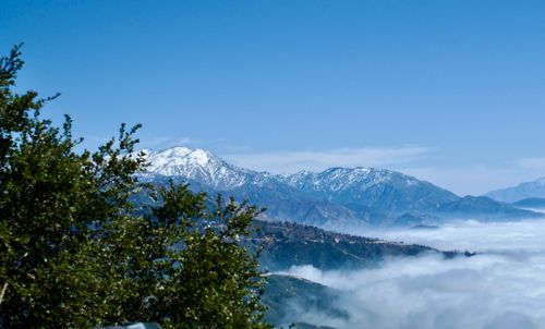 Free Breathtaking view of snow-covered San Bernardino Mountains above clouds in Crestline, California. Stock Photo