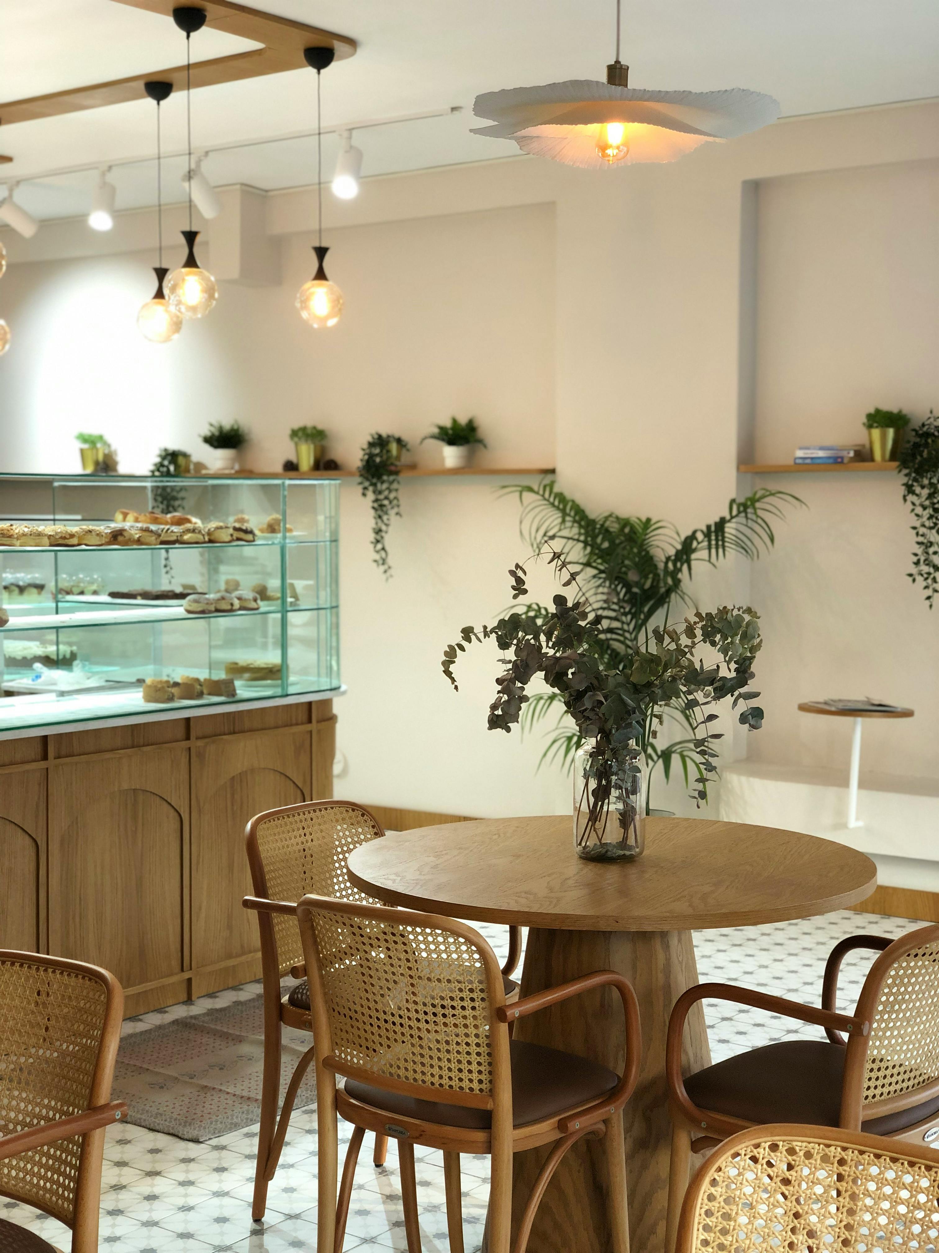 Cozy cafe interior with elegant decor, pastries, and natural lighting. Perfect for a relaxing coffee break.